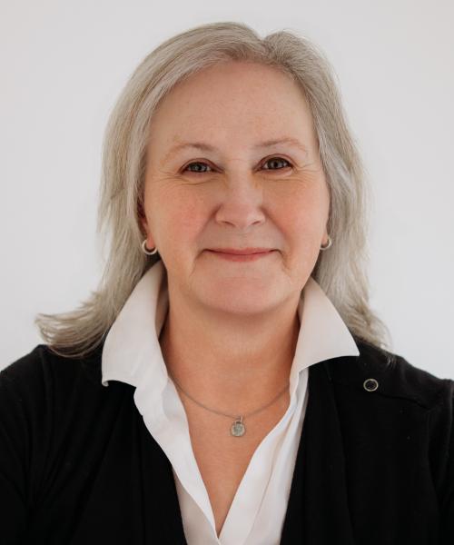 photo of woman wearing white shirt and black cardigan