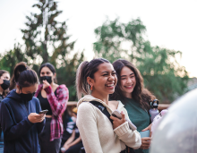 students laughing together in a group outside