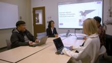 Dr. Min Sun at a conference table showcasing Colleague software