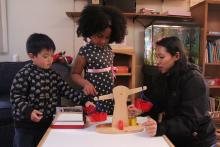 Children working with faculty