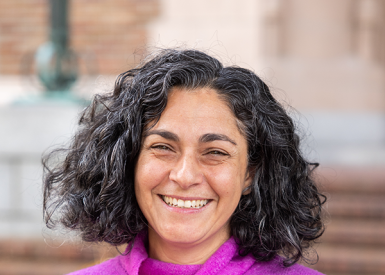 Deborah Massachi smiles in a photo taken in front of Miller Hall.